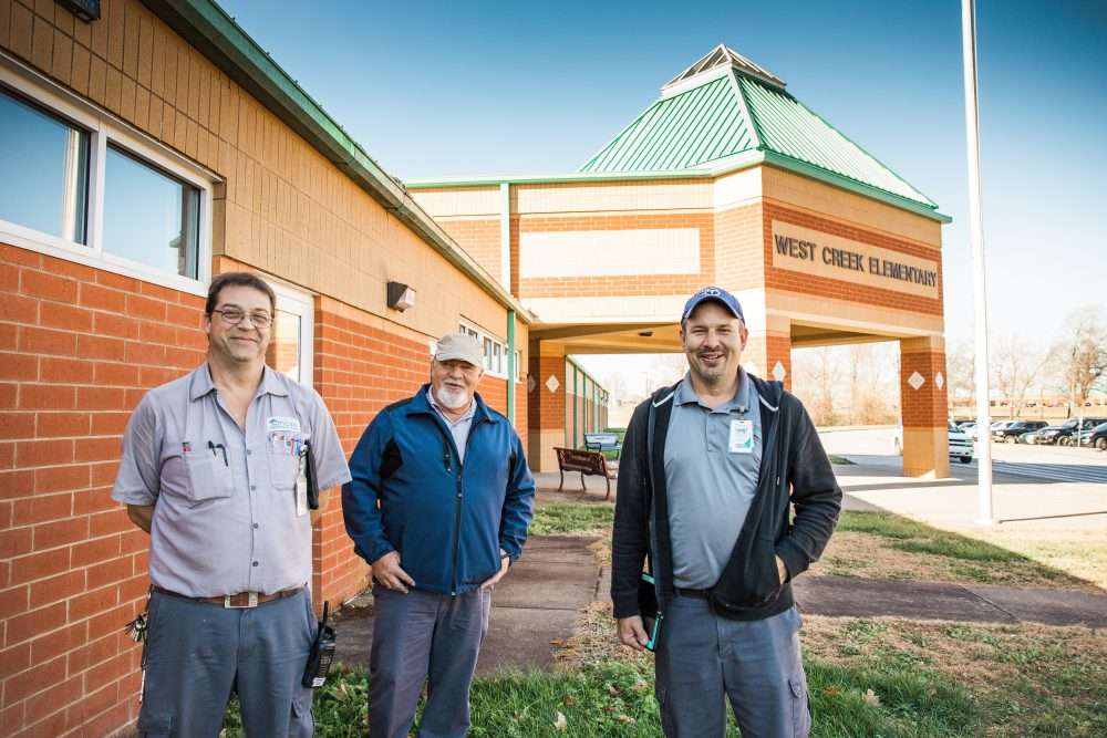 maintenance staff outside building