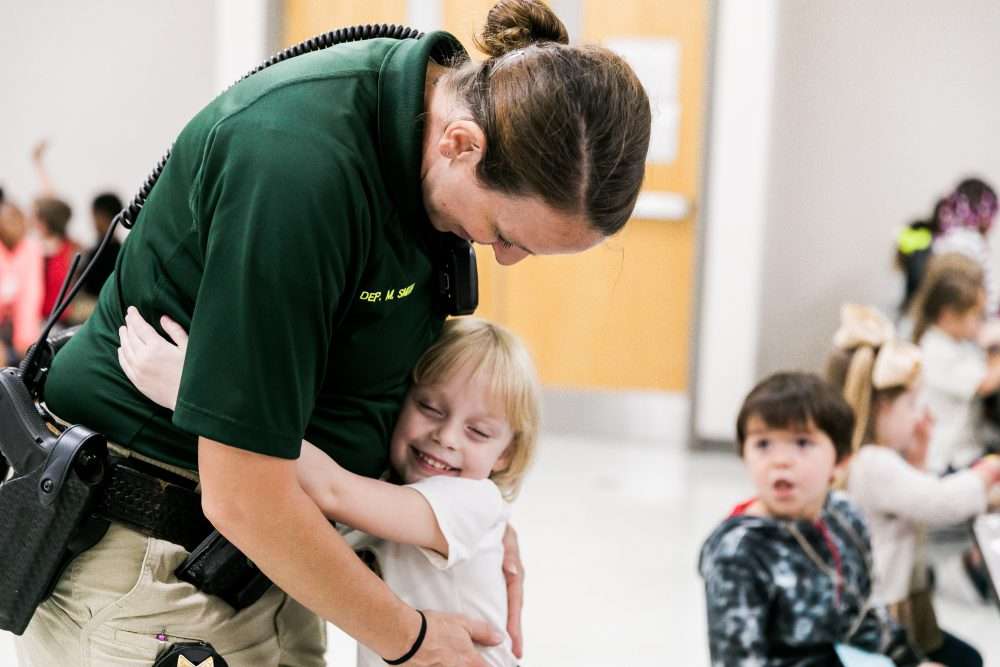 SRO hugs elementary student