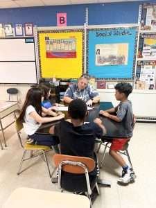substitute teacher at desk