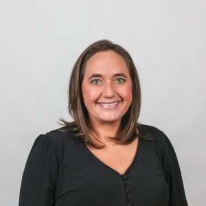 woman with brown hair black shirt blank background