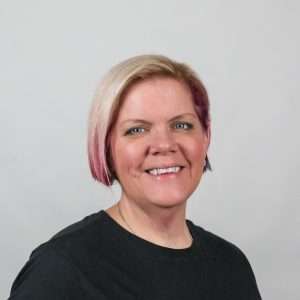 woman with pink hair black shirt blank background