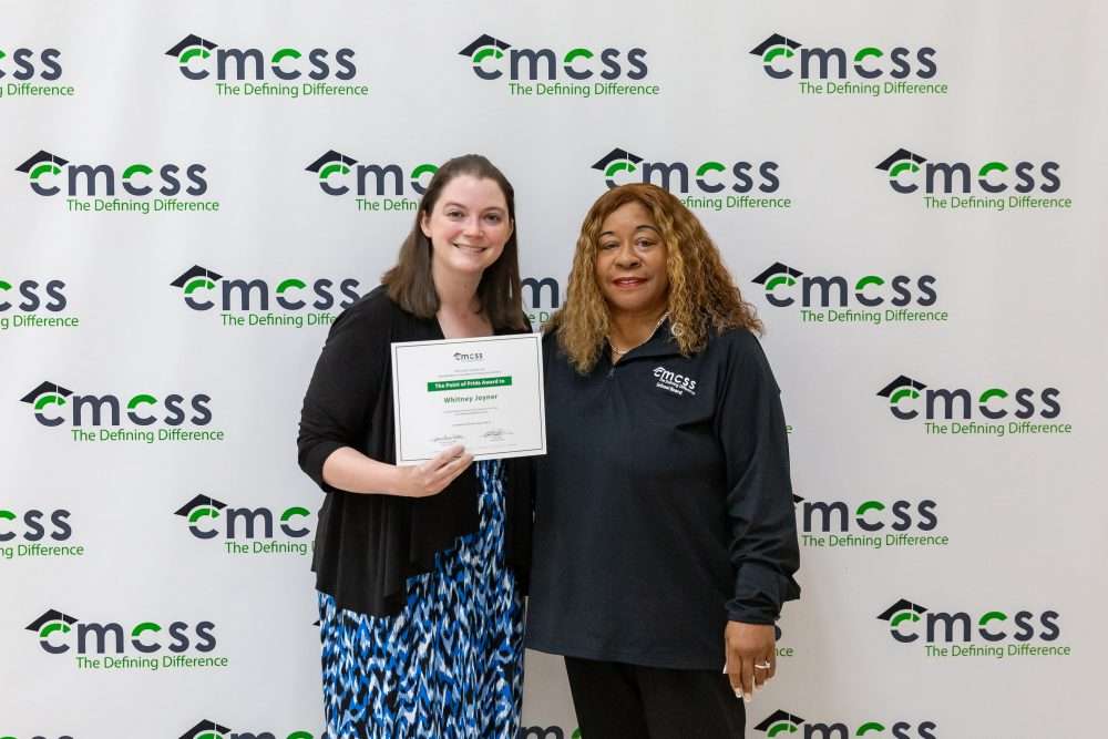 teacher and school board member with award