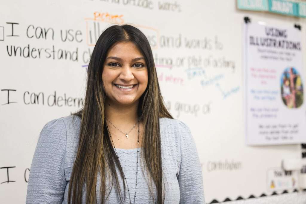 young teacher in front of board