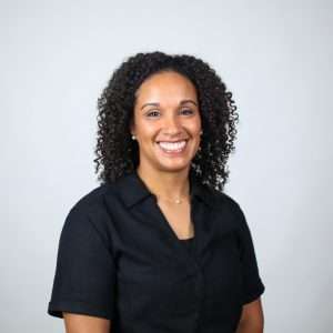 smiling woman with black hair black shirt blank background