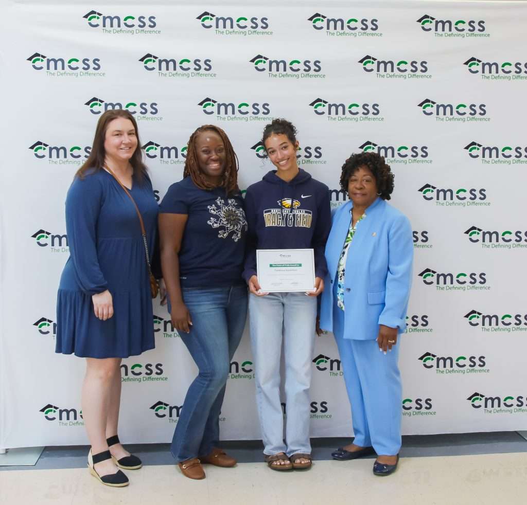 four females posing with an award