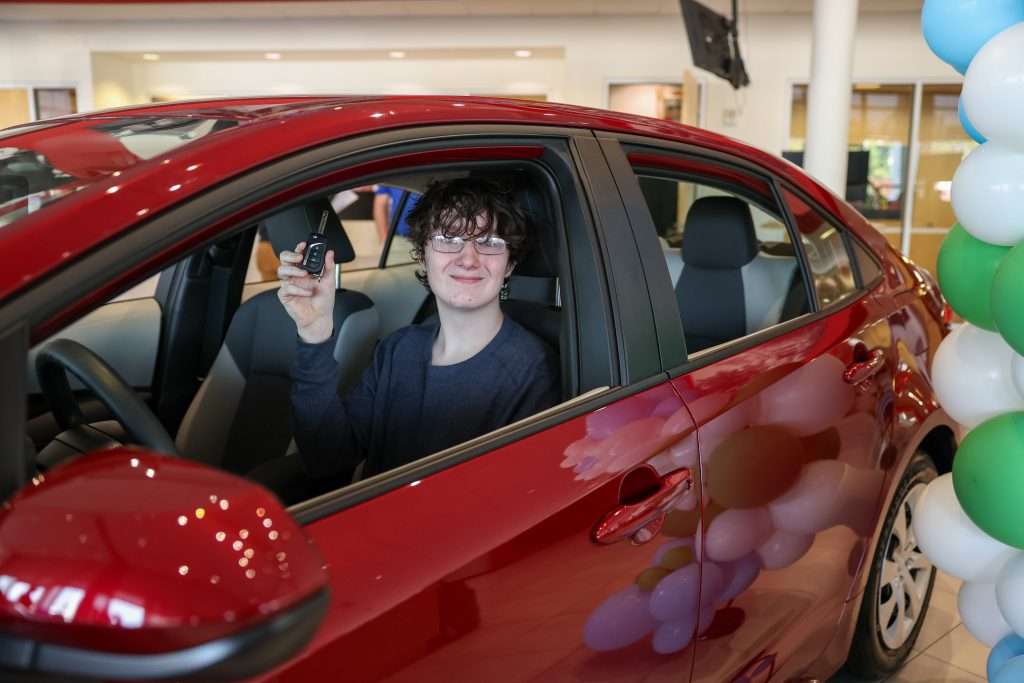 Male student in car with key