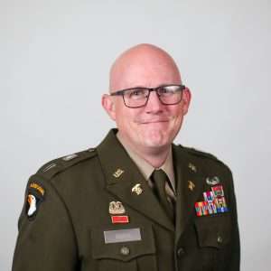 man in military uniform wearing glasses blank background