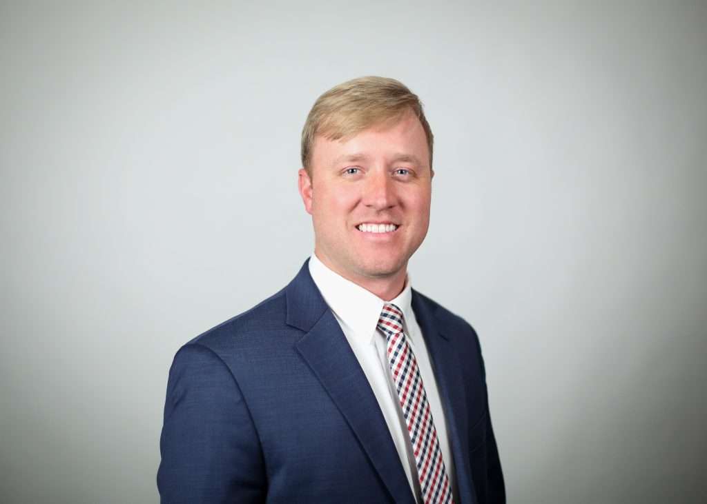 grant epperson smiling in blue suit
