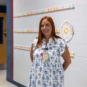 teacher stands in hallway