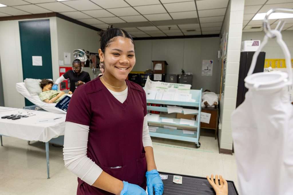Student wearing maroon scrubs