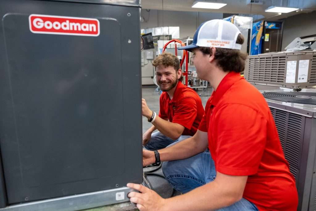 Students working on ac unit
