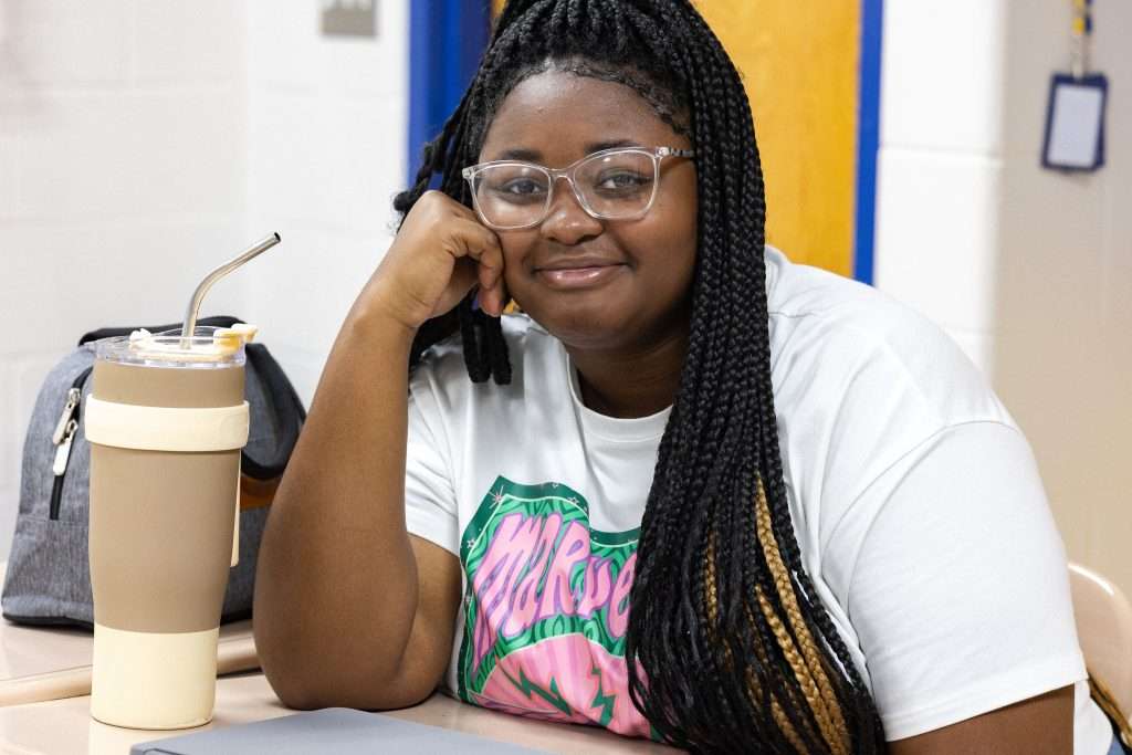 student sitting at desk with water bottle