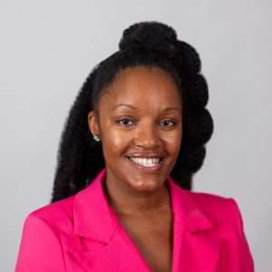 Headshot of Arlinda Baxter (woman with black hair and pink jacket)