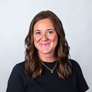 Headshot of Kristin Heimpel (woman with brown hair and black shirt)