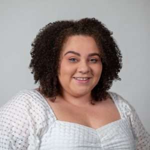 Headshot of Abigayle Redd (woman with brown hair and white shirt)