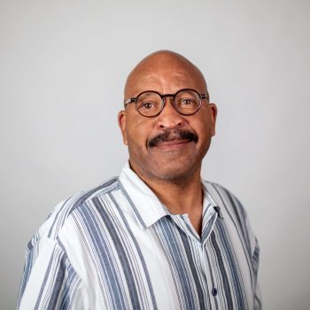 Headshot of Darryl Anderson (man with mustache and blue and white shirt)