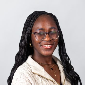 Headshot of Phasia Karyeah (black hair and light shirt)